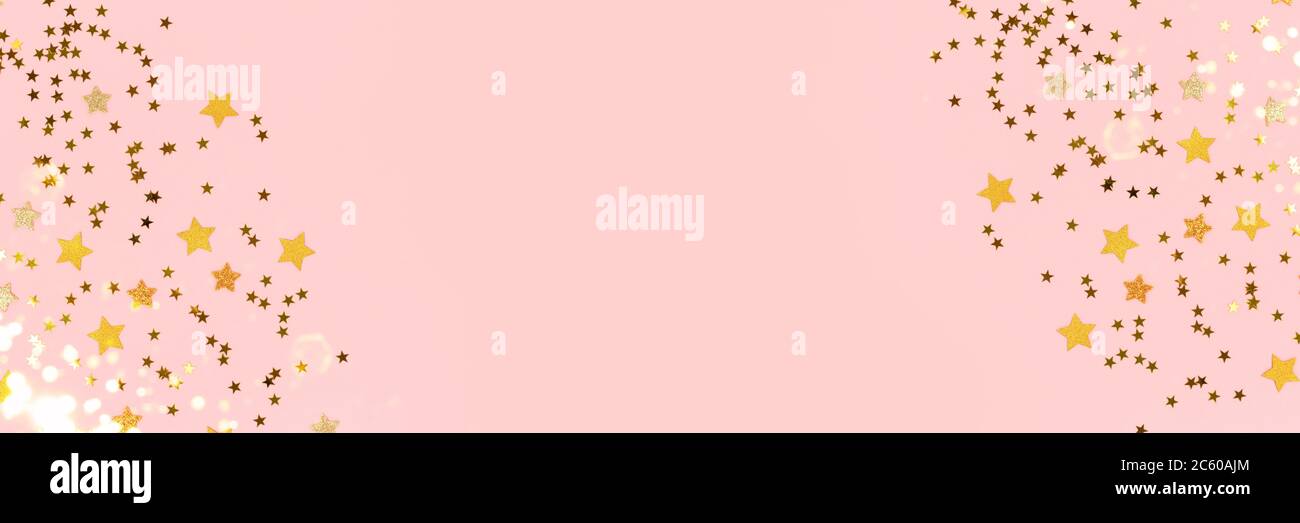 Frame made of gold stars confetti scattered on a pink pastel background ...