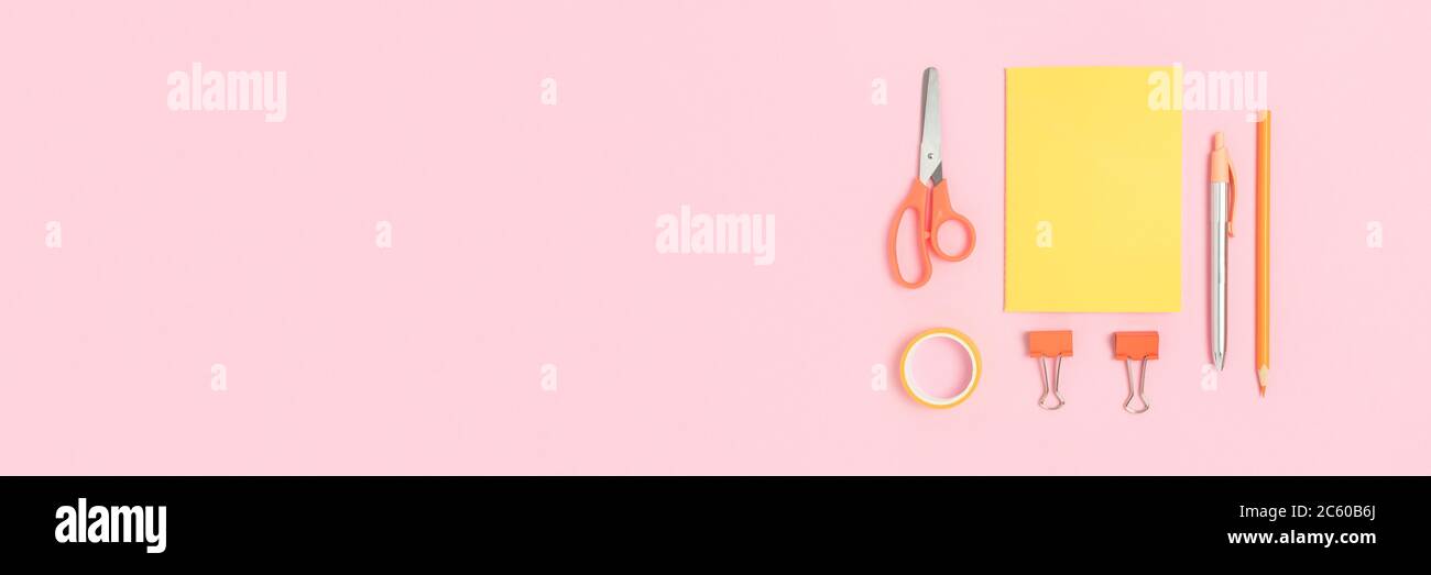 Set of yellow stationery on a pink pastel background. School banner ...