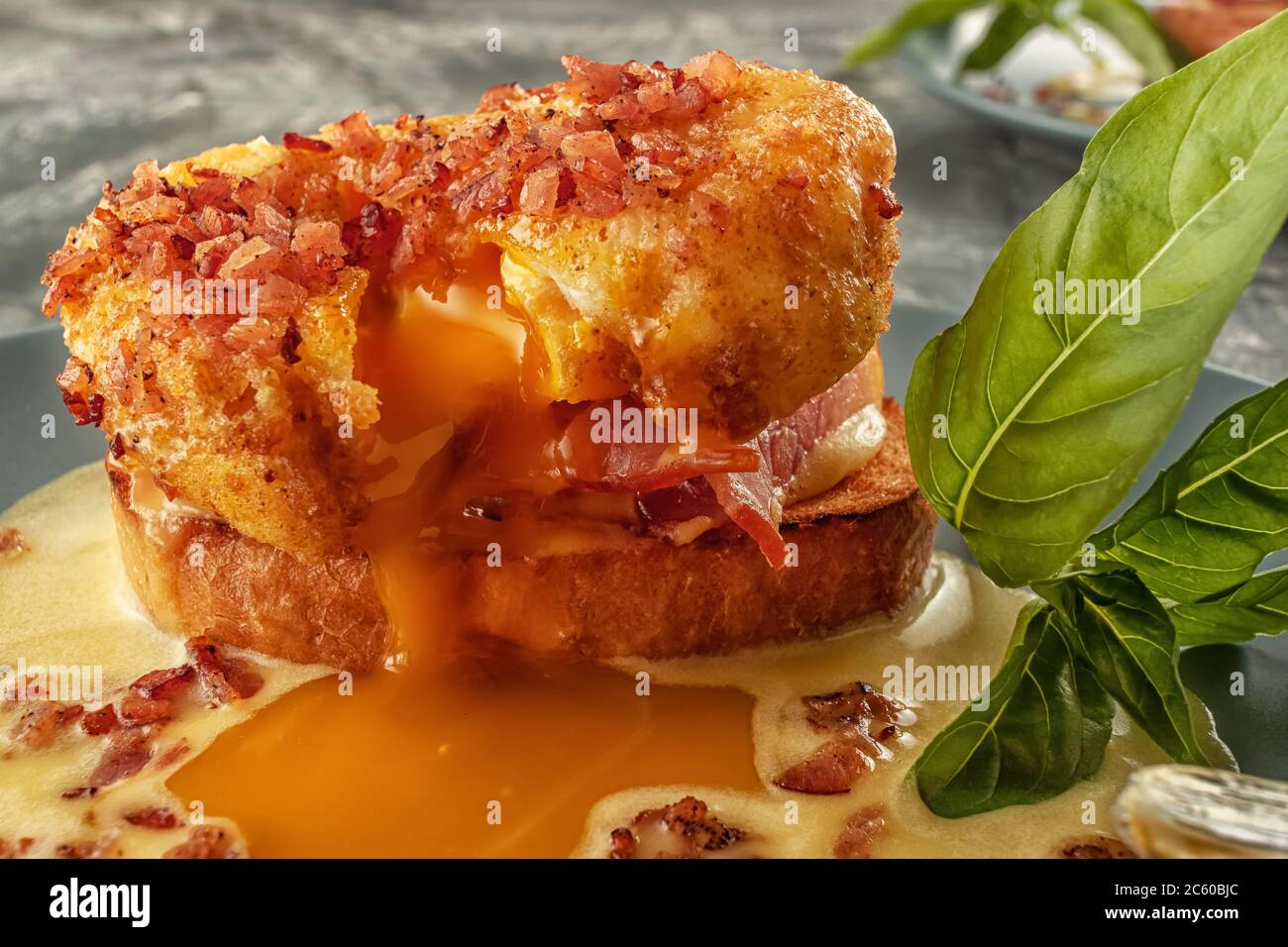 Eggs Benedict on toasted muffins with ham and sauce Stock Photo Alamy