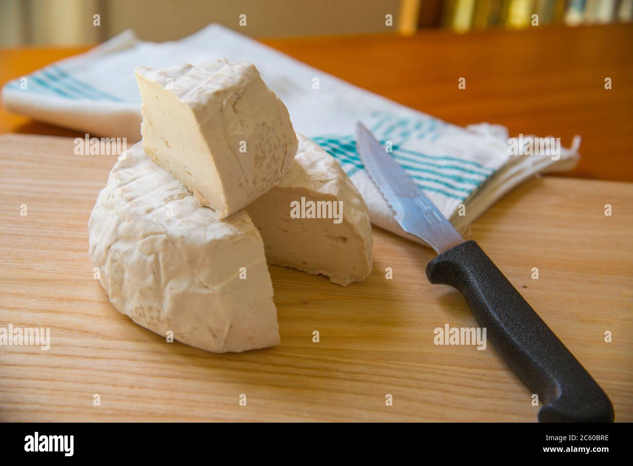 Cottage cheese on wooden chopping board. Still life. Stock Photo