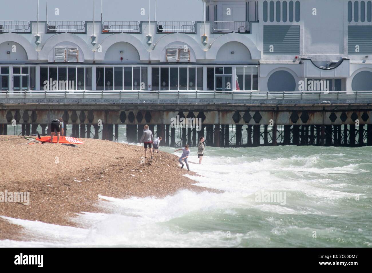 Southsea, Hampshire, UK. 23rd  May 2020. Despite blustery winds and a rough Solent, day-trippers gather at Southsea adhering on the whole to governmen Stock Photo