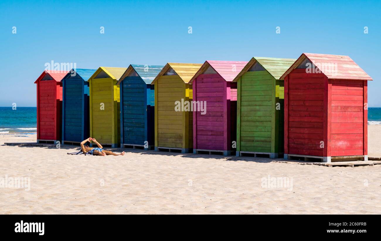 wooden huts, painted in bright colors and gabled roof in San Juan beach (Costa Blanca, Alicante), Spain. Stock Photo