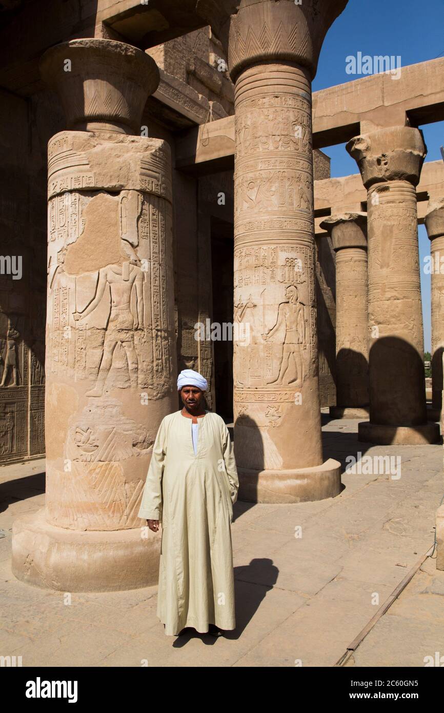 Caretaker, Columns with Reliefs, Temple of Sobek and Haroeris, Kom Ombo, Egypt Stock Photo