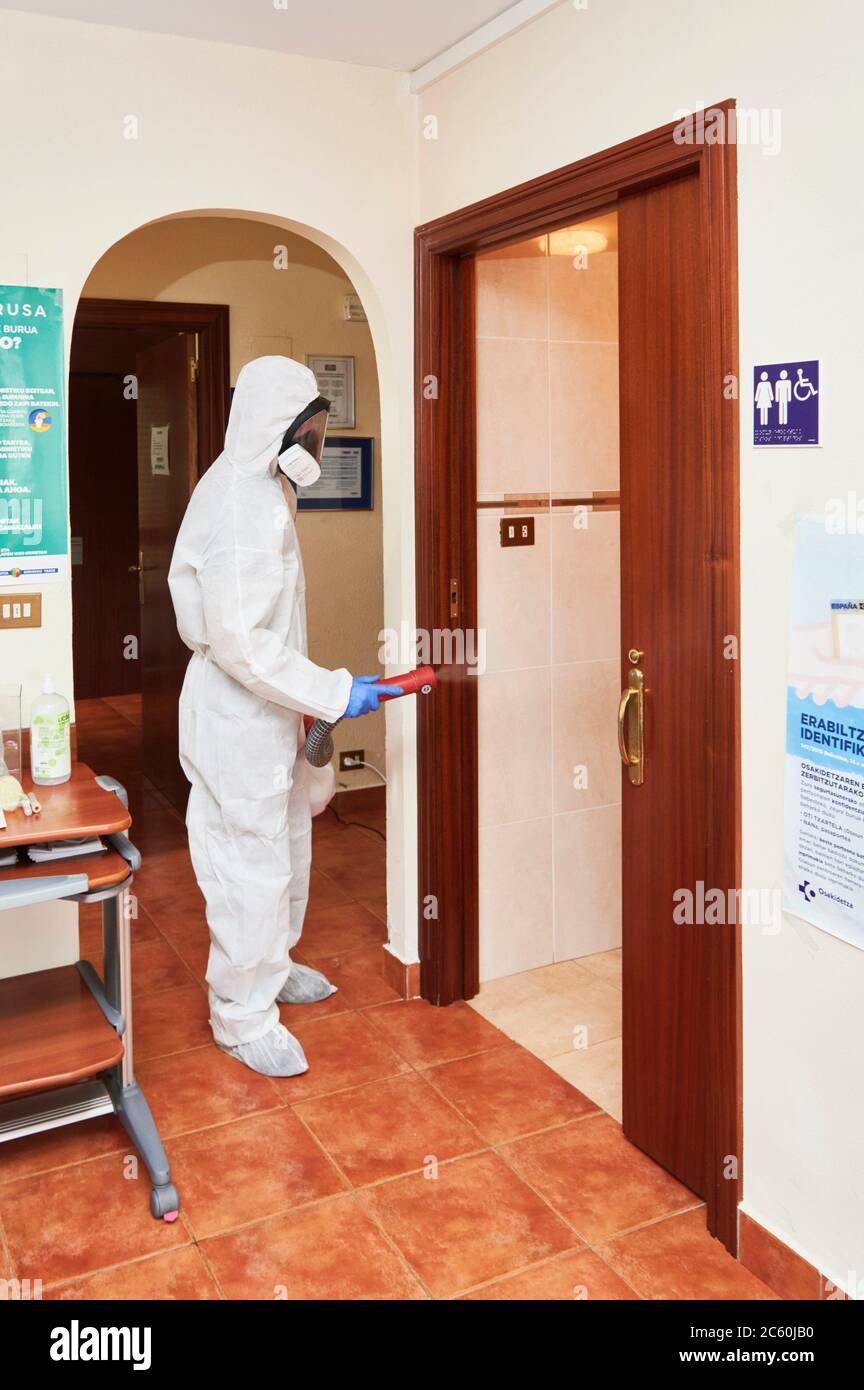 Technician disinfecting medical center with chemical detergents against Covid-19. Stock Photo