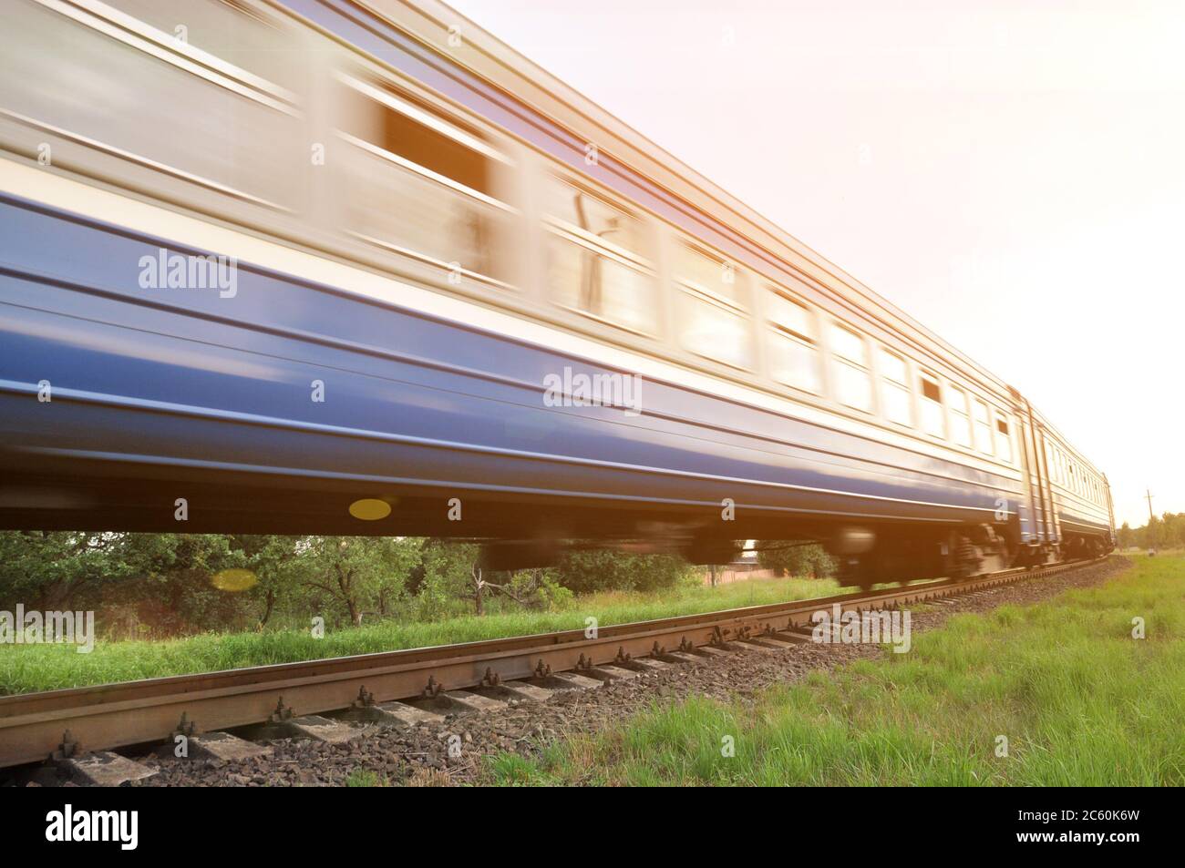 A high-speed diesel train moves quickly by rail. Blur Stock Photo