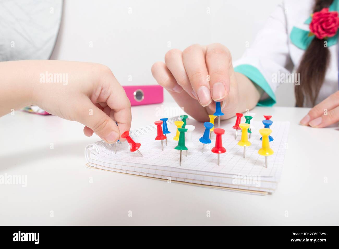 Doctor psychologist pediatrician is engaged with a child with