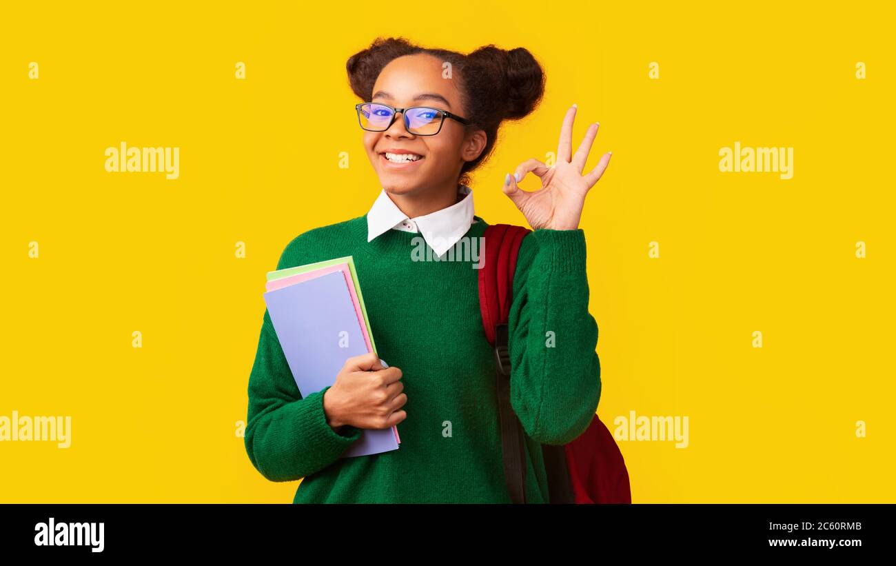 Happy young afro woman showing ok sign gesture Stock Photo - Alamy
