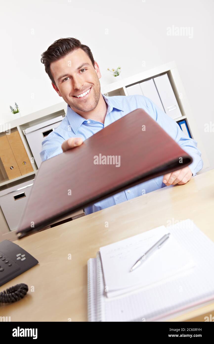 Applicants hand over their documents to HR staff during the job interview Stock Photo