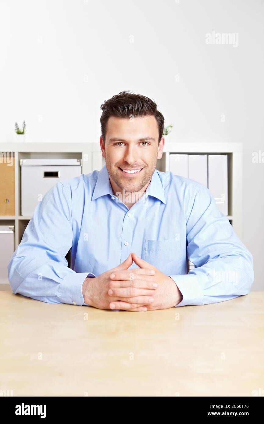 Manager at the empty desk listens attentively Stock Photo