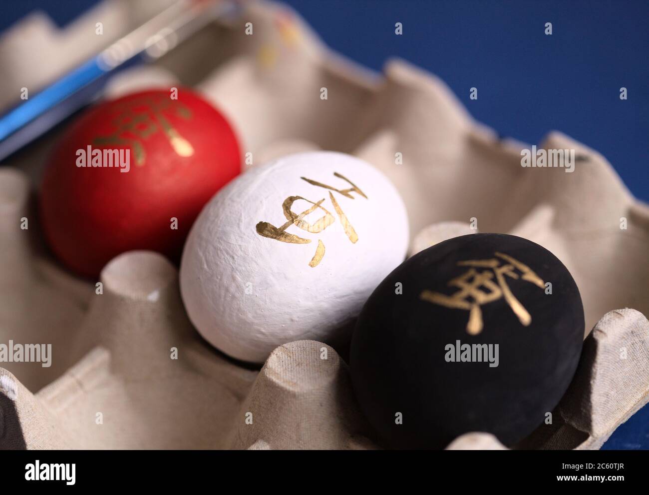 chinese-or-japanese-symbol-dan-meaning-egg-painted-on-colorful-eggs