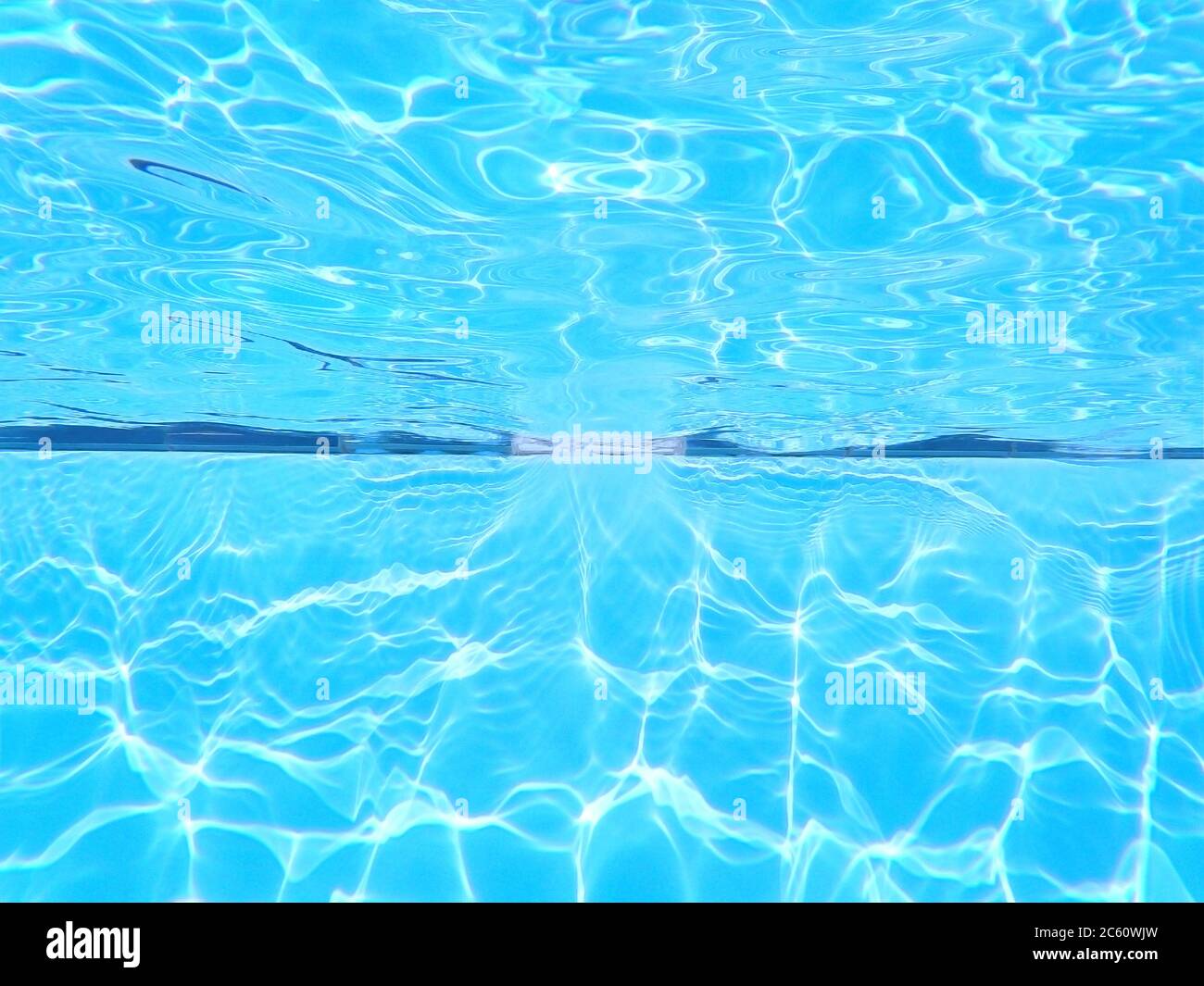 Swimming pool underwater background. Chlorine water treatment and  sanitation. Empty copy space with no people for Editor's text. Stock Photo