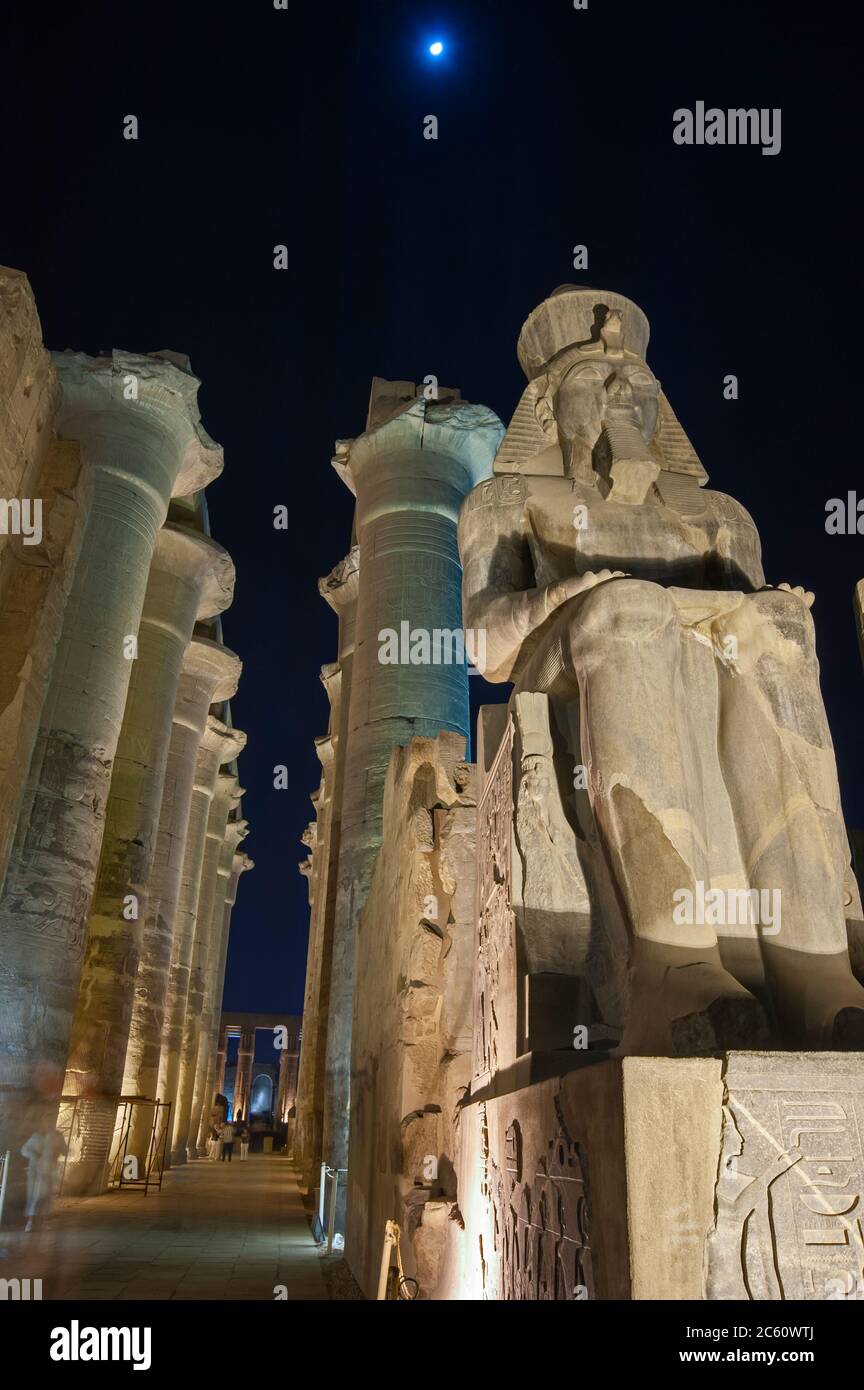 Large statue of Ramses II with columns in hypostyle hall at ancient ...