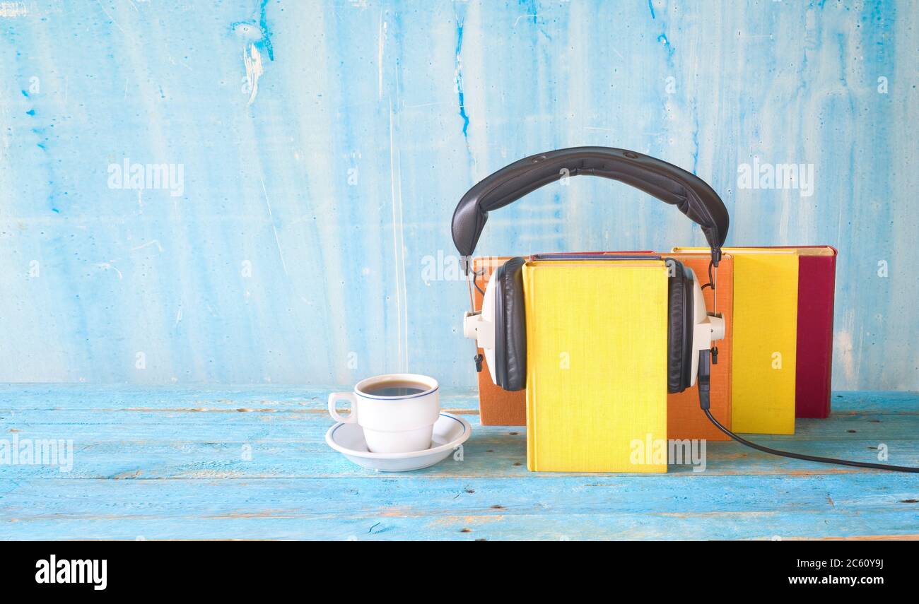 audio book concept with book, headphones and cup of coffee, panorama format on grungy background, good copy space Stock Photo