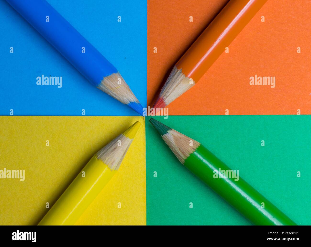 Colored pencil crayons arranged on matching colored card surface Stock Photo