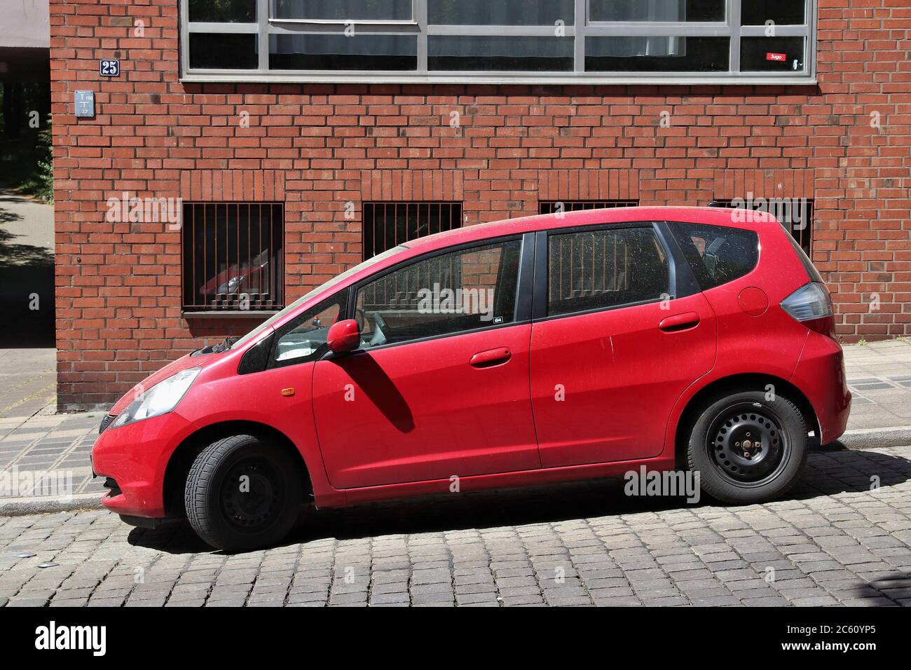 NUREMBERG, GERMANY - MAY 7, 2018: Red Honda Jazz compact car parked in Germany. There were 45.8 million cars registered in Germany (as of 2017). Stock Photo