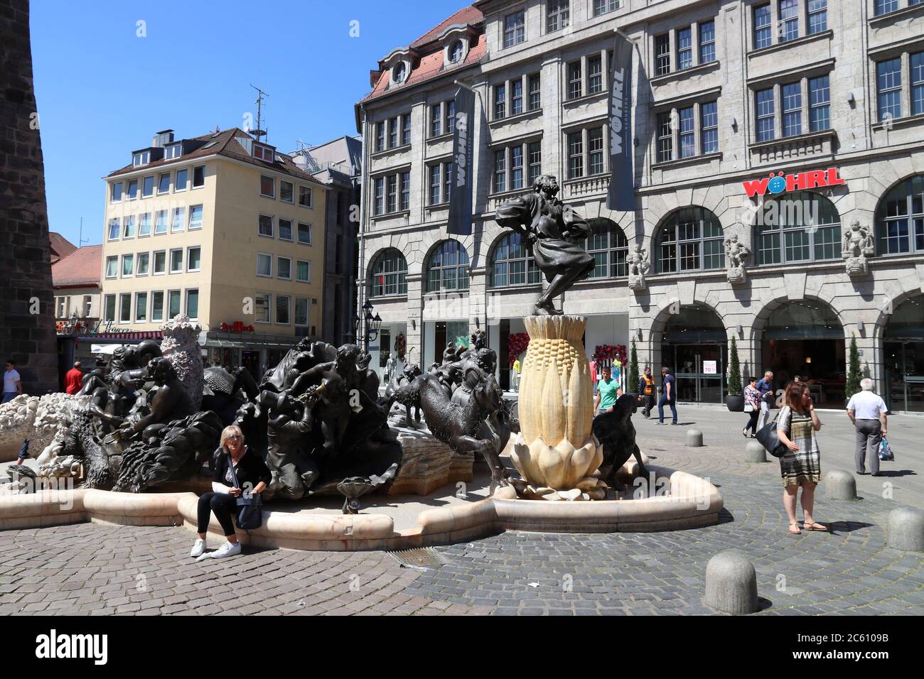 NUREMBERG, GERMANY - MAY 8, 2018: People visit Ehekarussell controversial fountain at Ludwigsplatz (Ludwig Square) shopping area in Nuremberg Old Town Stock Photo
