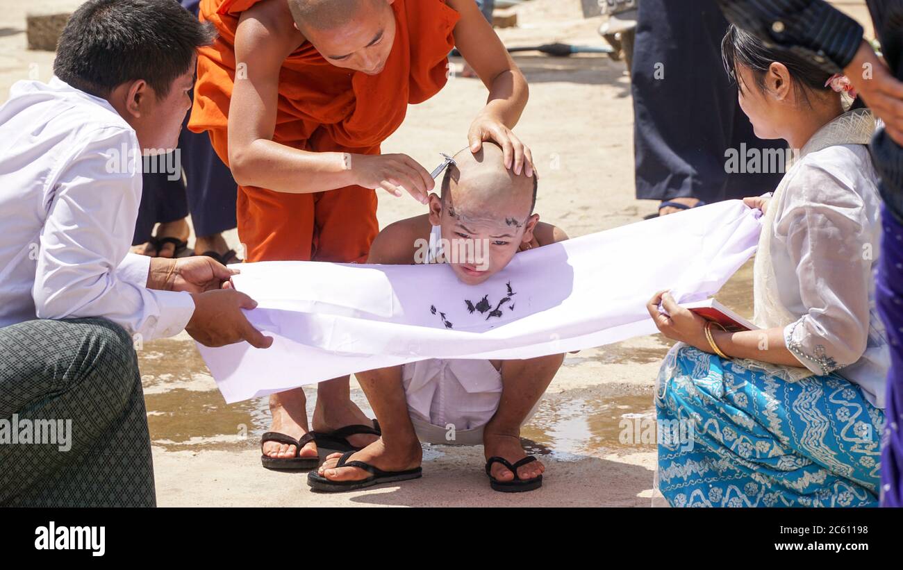 Monk child getting a haircut in public in Kalaw city, Myanmar / Burma. Stock Photo