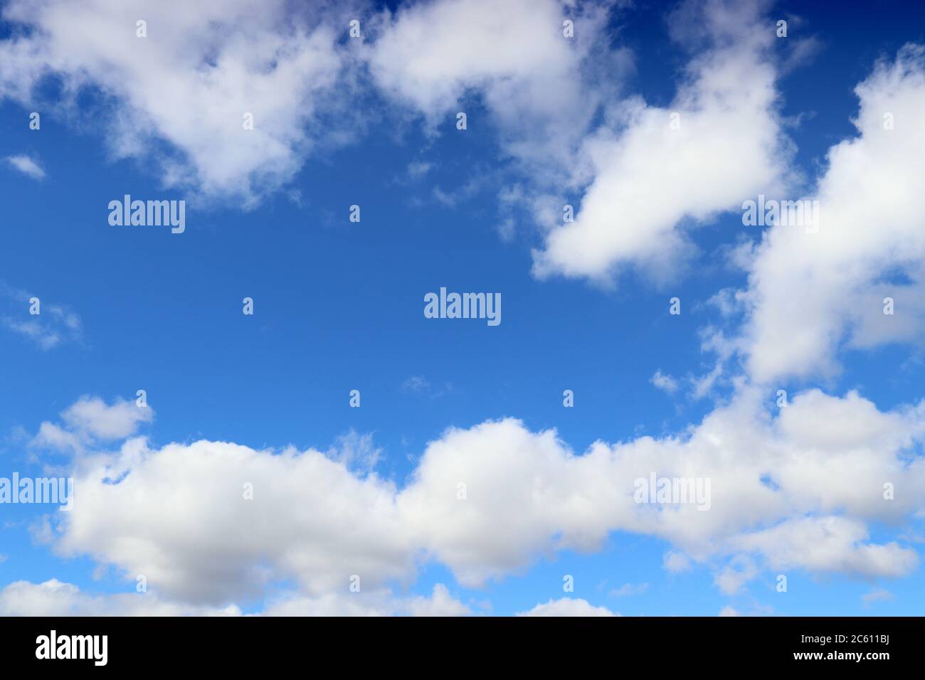 White clouds blue sky background. White fluffly clouds texture. Stock Photo