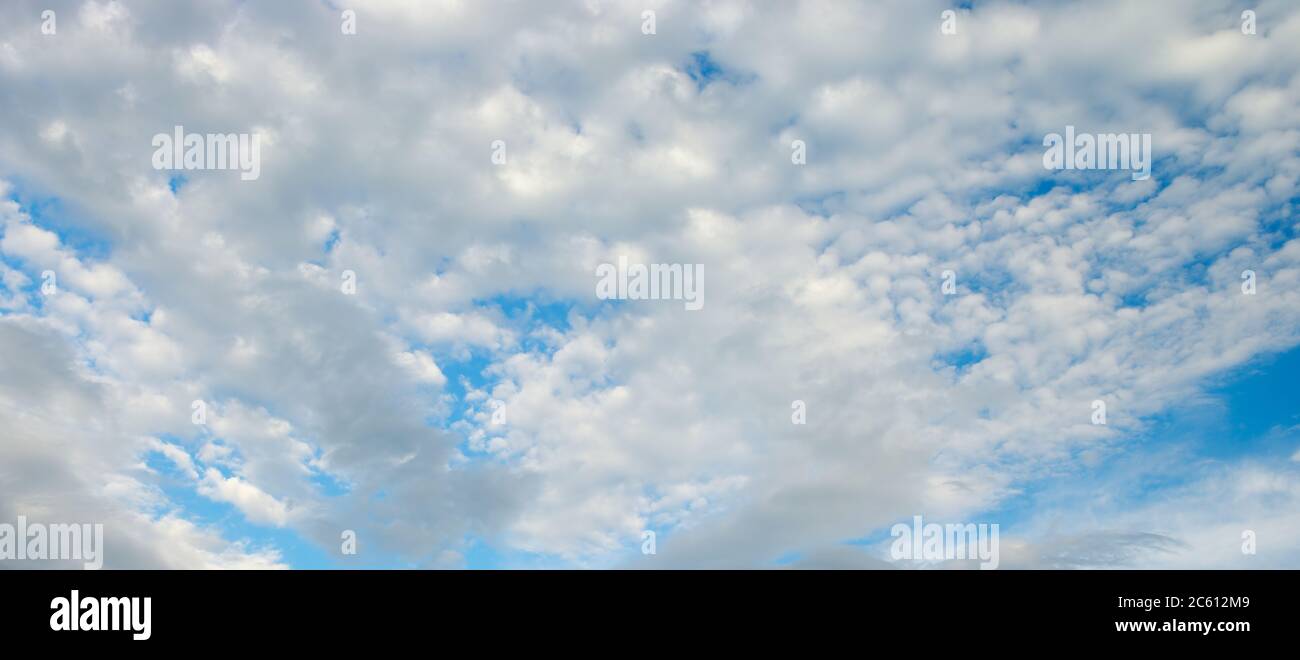 Fluffy white cumulus clouds against bright blue sky Stock Photo - Alamy