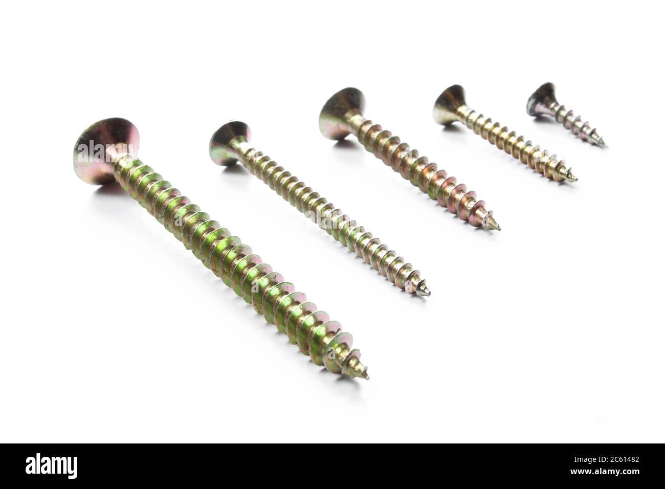 Set of metallic screws of different sizes isolated on white background