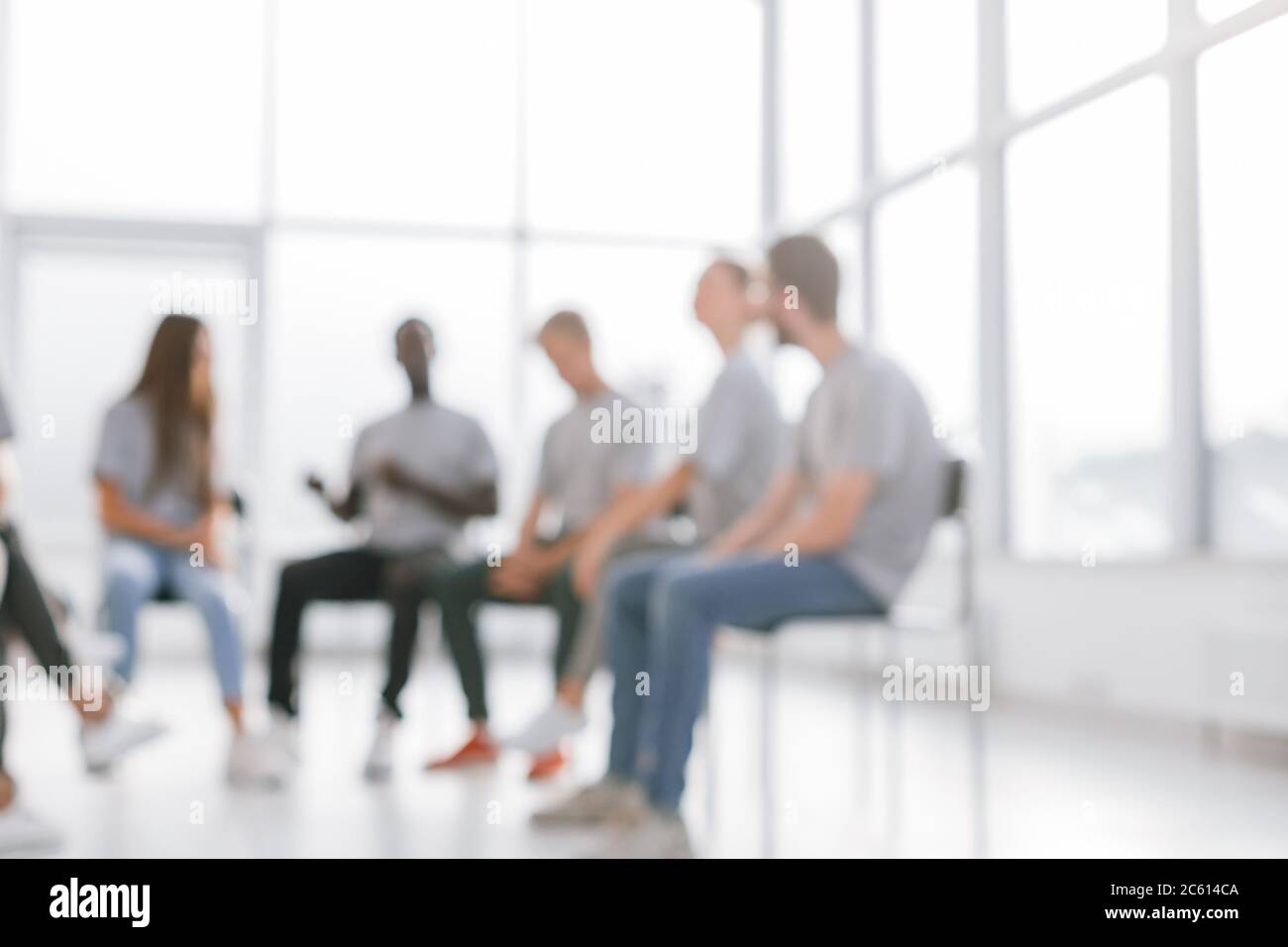 background image of a group of young people at a meeting in a ...