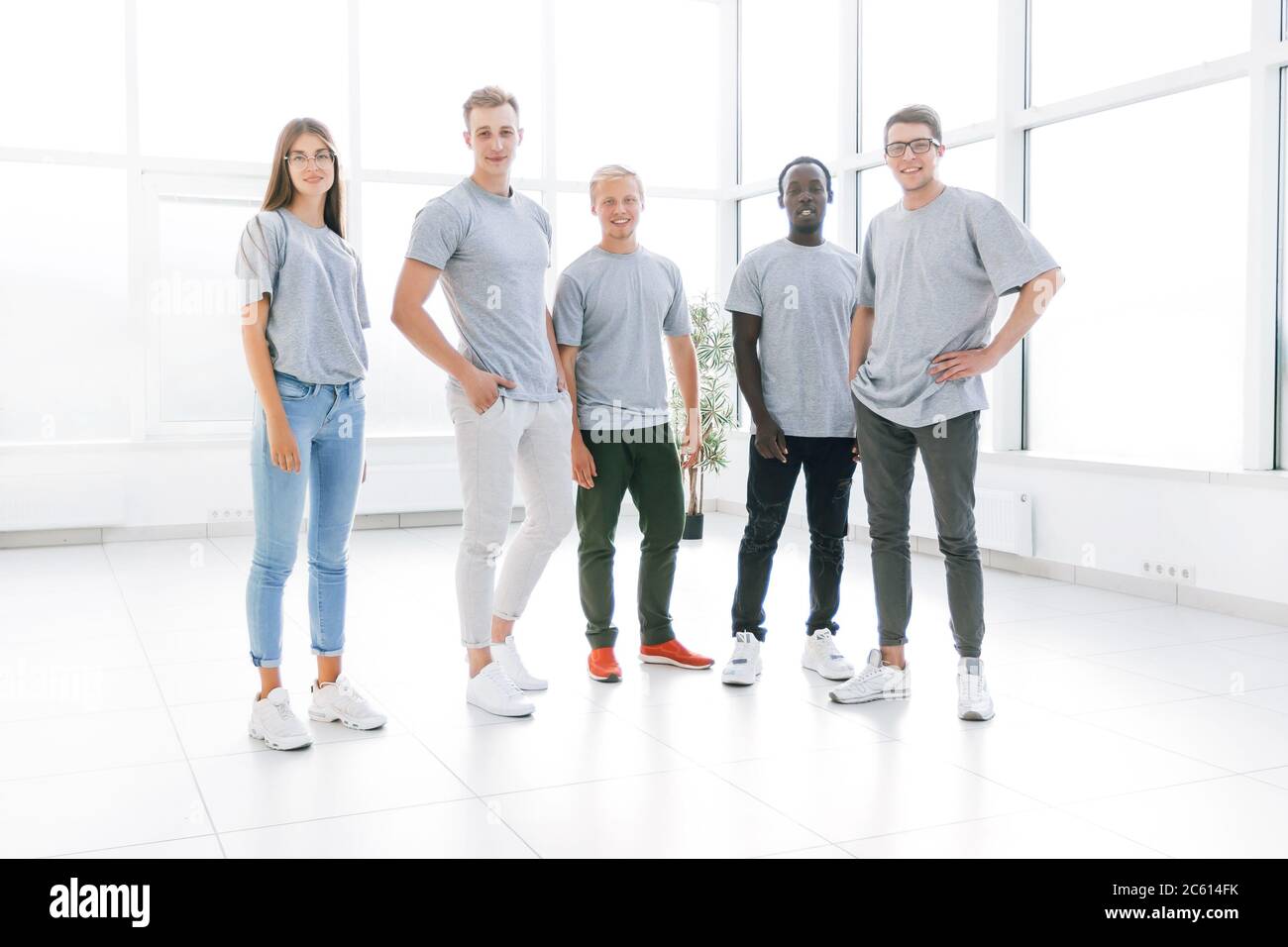group of young people standing in an empty office Stock Photo - Alamy