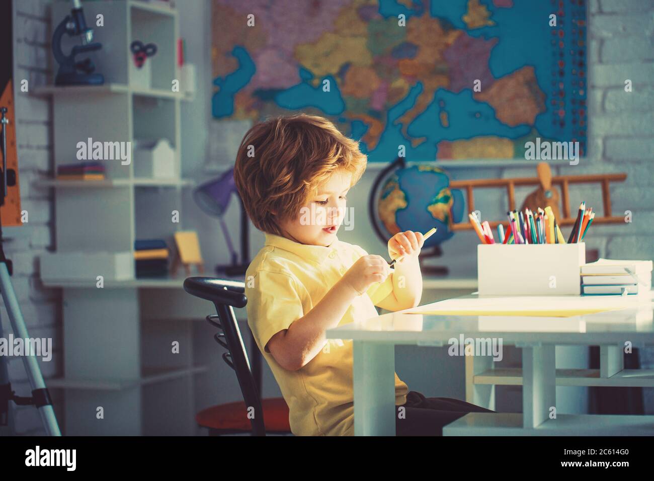 Portrait of little boy sitting in drawing class Stock Photo - Alamy