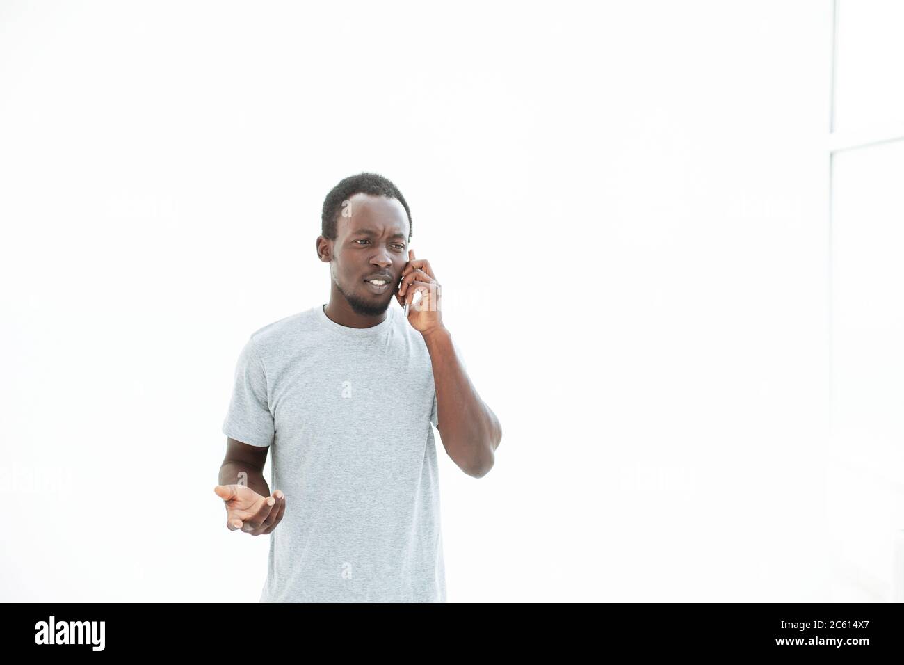 serious young man talking on his smartphone. Stock Photo