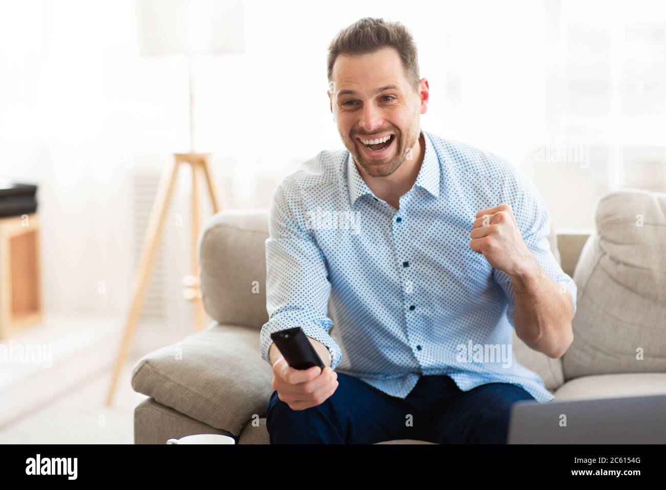 Emotional man watching football game at home Stock Photo