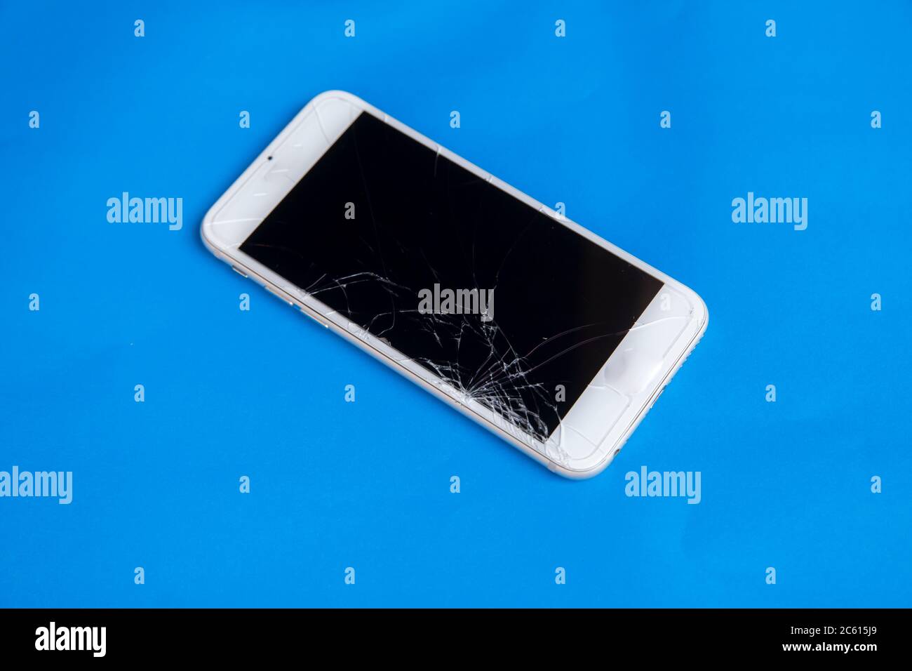 Broken mobile phone. Cracked smartphone screen Stock Photo