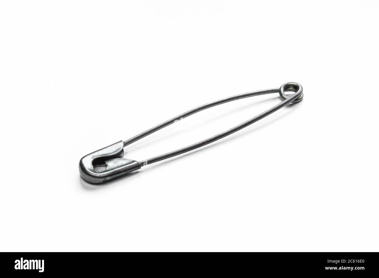 Grey metallic safety pin isolated on white background. Closed single needle pin Stock Photo Alamy
