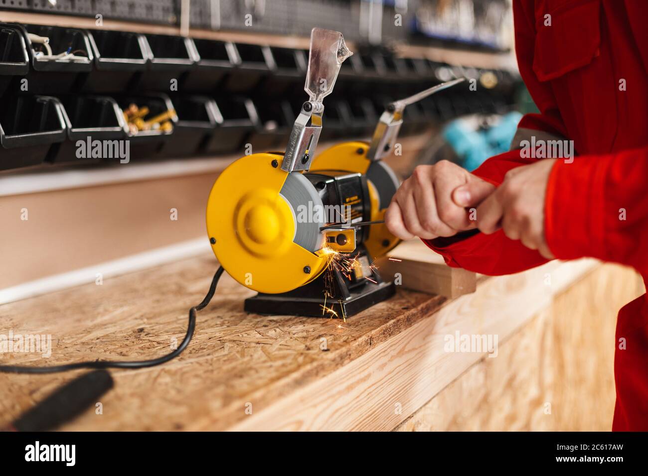 Close up foreman using yellow knife sharpener in workshop isolat Stock Photo