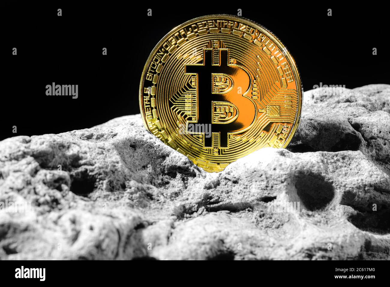 Golden Bitcoin Coin on grey rock . Bitcoin cryptocurrency. Business concept. Stock Photo