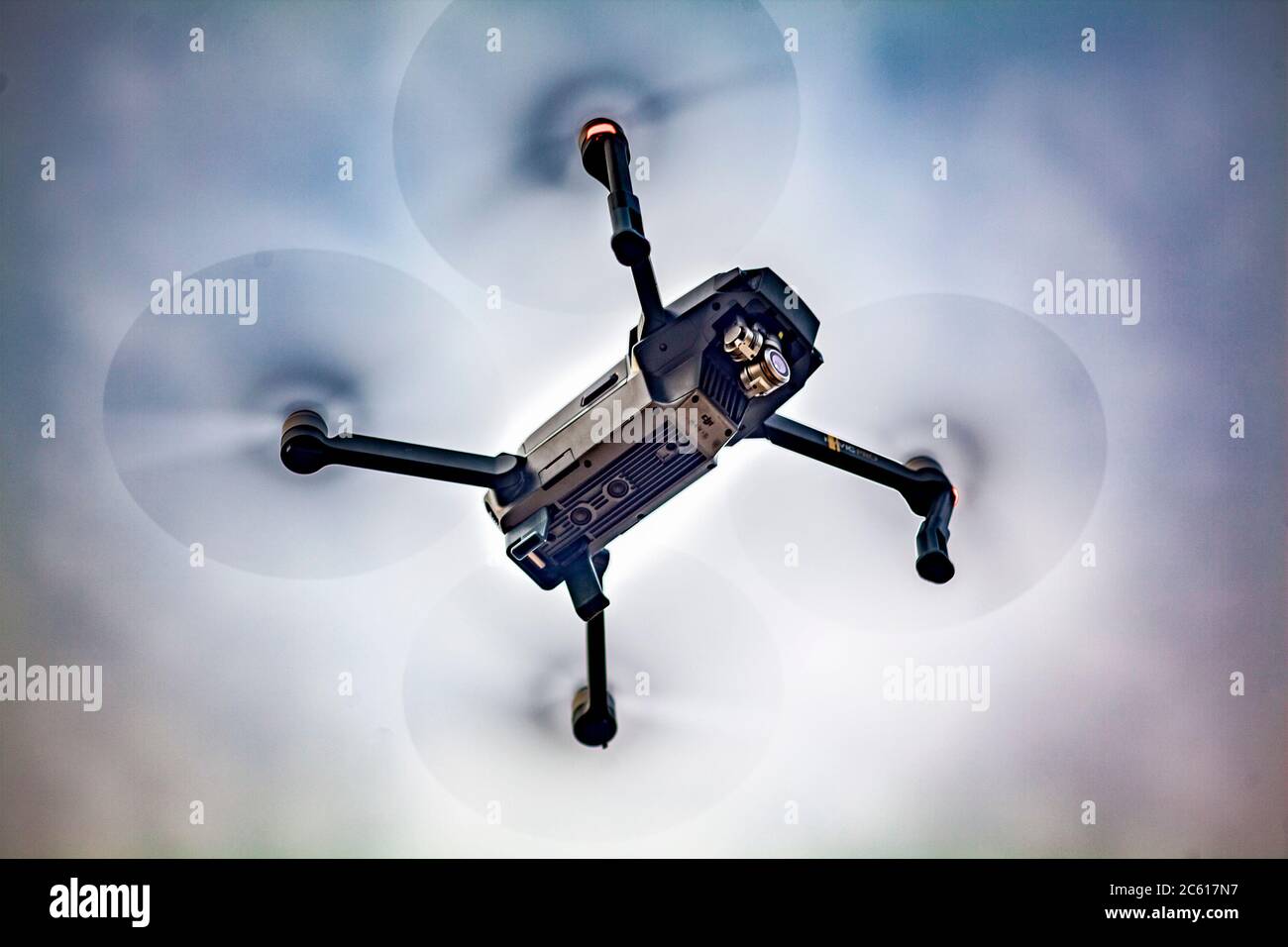 Close up of a wifi enabled, recreational DJI Mavic Pro Aerial 4K Camera Drone Quadcopter flying low overhead. Stock Photo