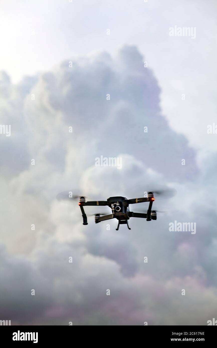 Close up of a wifi enabled, recreational DJI Mavic Pro Aerial 4K Camera Drone Quadcopter flying low overhead. Stock Photo