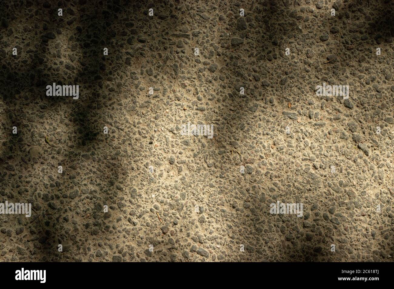 Asphalt surface in the shade. Textured background Stock Photo