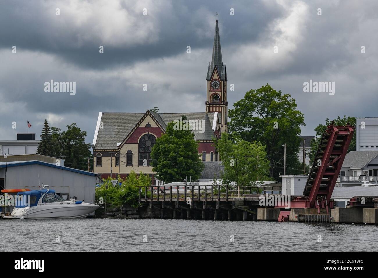 United Baptist Church on Lake Winnipesaukee, New Hampshire - baptist church spire seen from harbor in Laconia NH Stock Photo