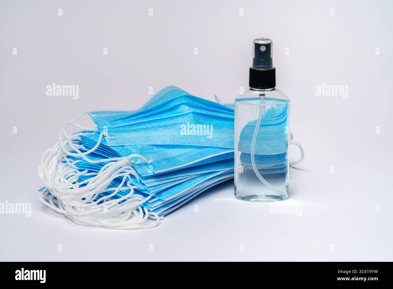 bottle of lotion, sanitizer or liquid soap and protective mask over ...