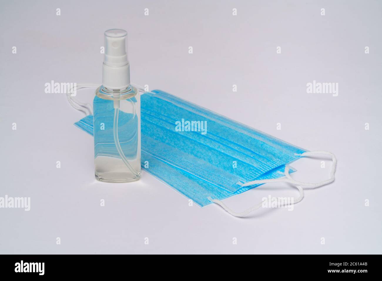 bottle of lotion, sanitizer or liquid soap and protective mask over ...