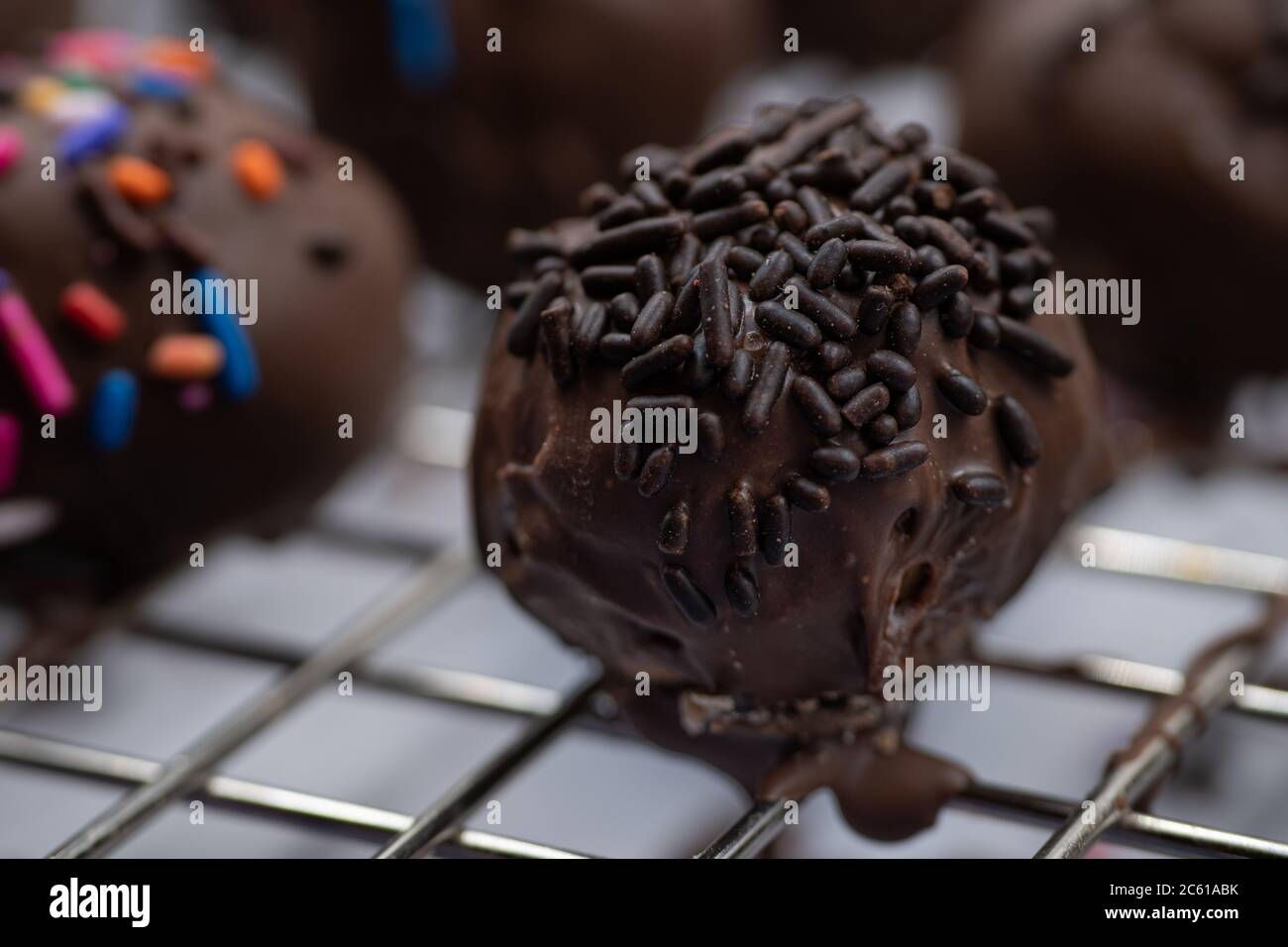 Chocolate donut holes with sprinkles Stock Photo Alamy