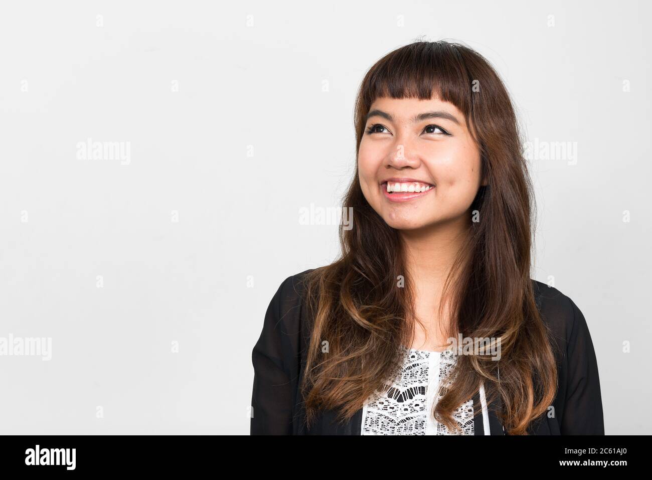 Portrait of happy young beautiful Asian woman thinking Stock Photo - Alamy