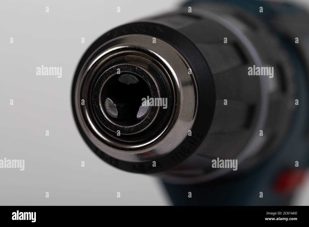 closeup electric drill without drill on an isolated white background