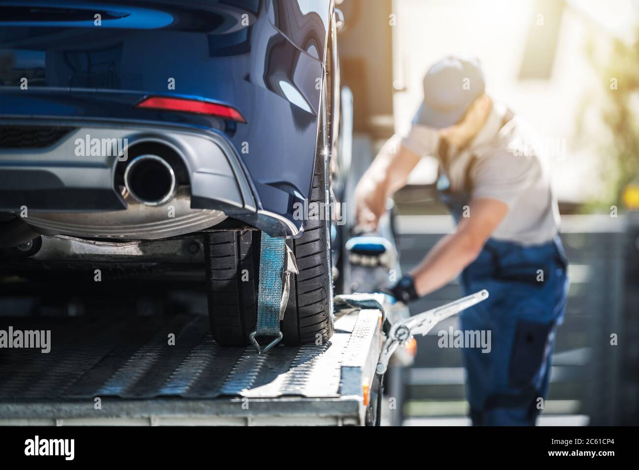 Towing Truck Delivery. Shipping Modern Vehicle to Car Dealership From