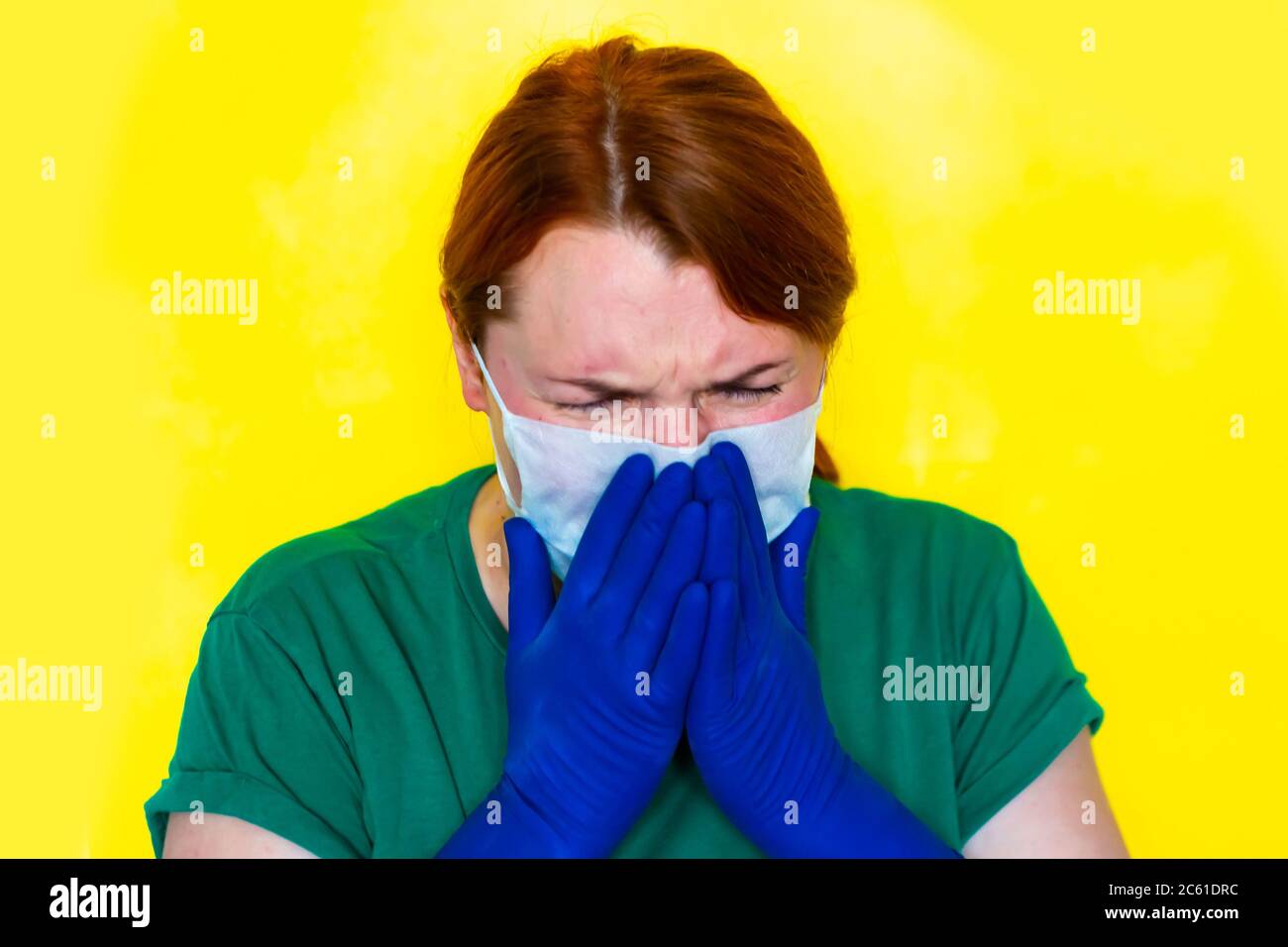 Redhead girl in medical gloves is sneezing in her hands, covid-19 concept  Stock Photo - Alamy