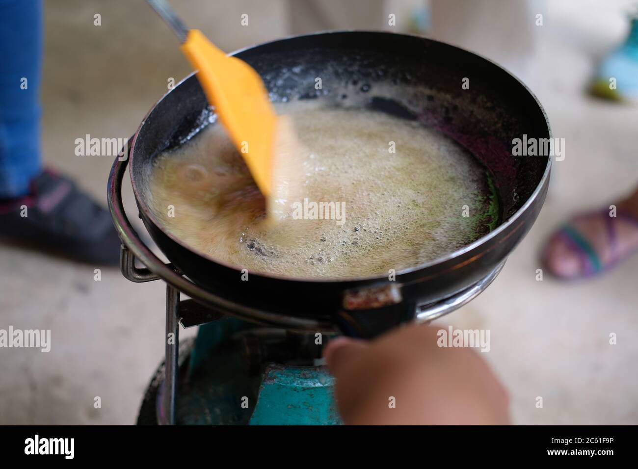heating cooking boiling sugar caramel syrup in pan Stock Photo Alamy