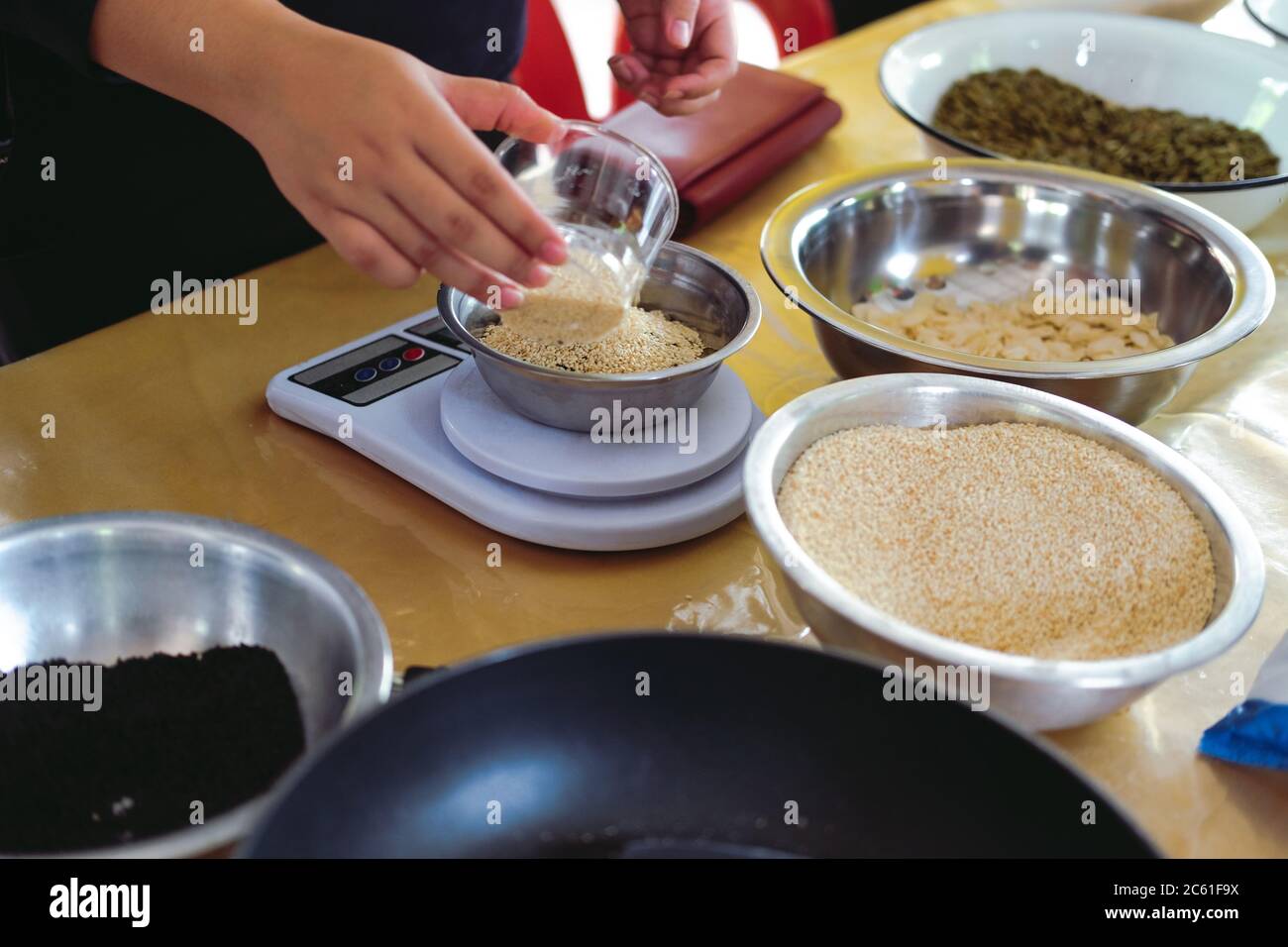 weighing sesame seed for making vegan cereal granula muesli bar Stock