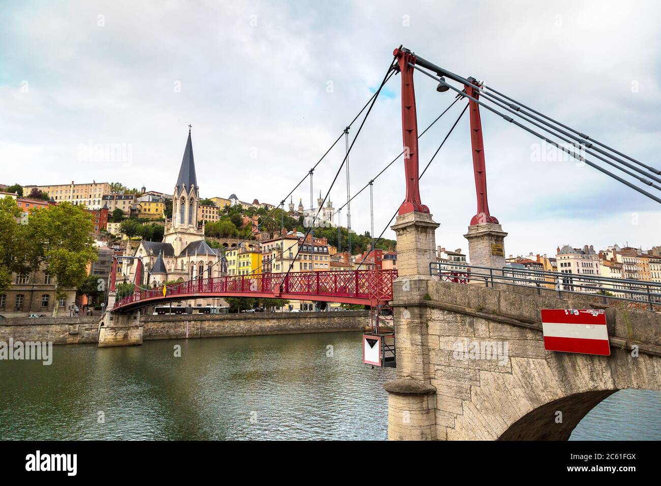 Pedestrian Saint Georges footbridge and the Saint Georges church in Lyon, France in a beautiful summer day Stock Photo