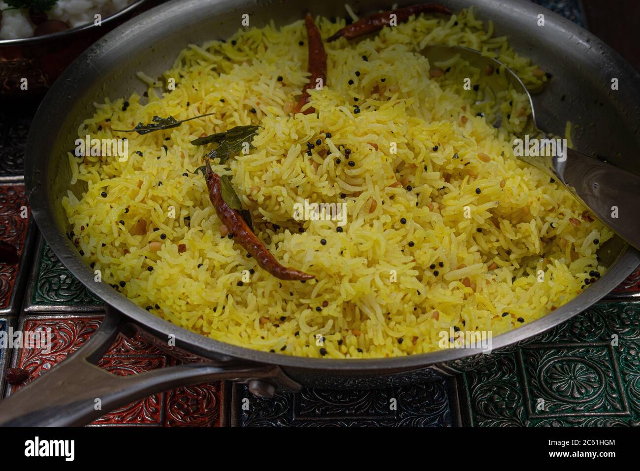 South Indian yellow turmeric rice in steel pan Stock Photo Alamy