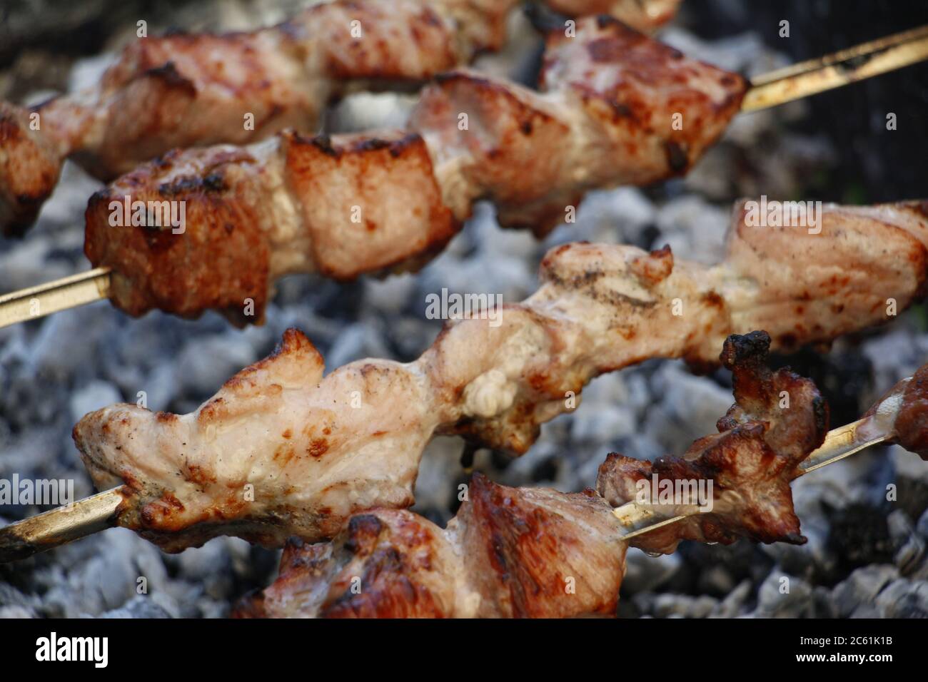 Cooking barbecue skewers. Marinated kebab is grilled on charcoal. Shish