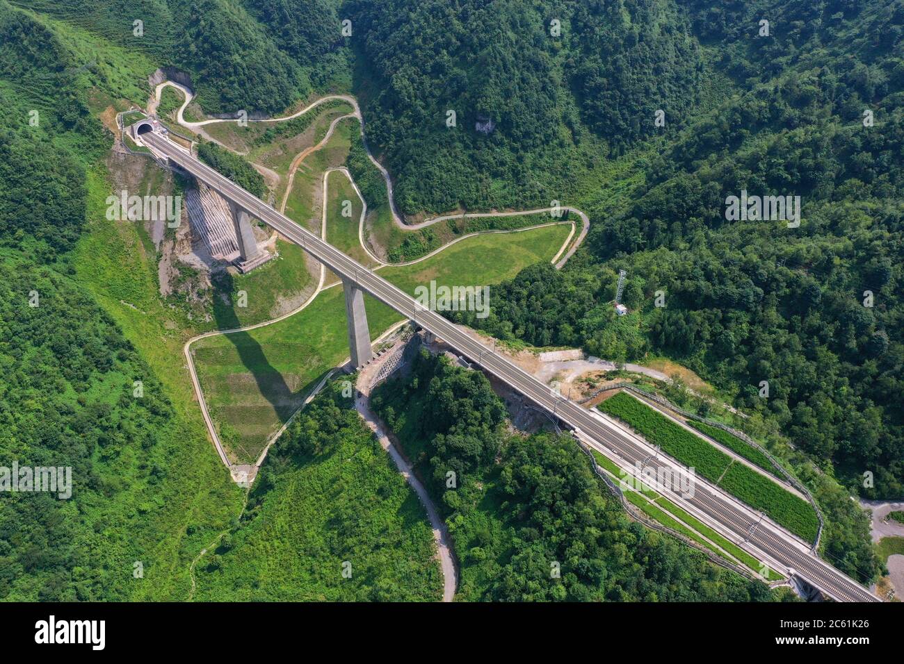 Liupanshui. 6th July, 2020. Aerial photo taken on July 6, 2020 shows a railway bridge along the Anshun-Liupanshui railway in southwest China's Guizhou Province. The Anshun-Liupanshui intercity railway, with a designed speed of 250 km per hour, is being prepared for opening. The railway will shorten the travel time between Guiyang and Liupanshui from the current 3.5 hours to about 1 hour, and Liupanshui City will be fully connected with the national high-speed rail network. Credit: Liu Xu/Xinhua/Alamy Live News Stock Photo